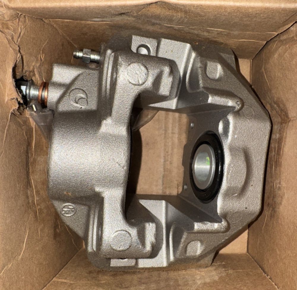 97-01693B OE Non Bracket Semi-Loaded Caliper, Genco – a box with a metal object inside it