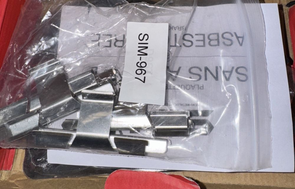 Rear Semi-Metallic Disc Brake Pads SIM-967 For Ram 1500 – a box of metal parts and a piece of paper