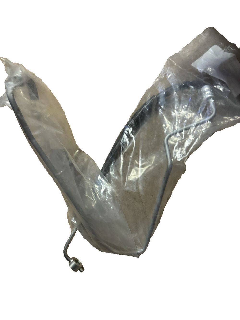 Sunsong 3402246 Power Steering Pressure Hose Assembly (Nissan), Sunsong North America – a piece of plastic wrap on a white background