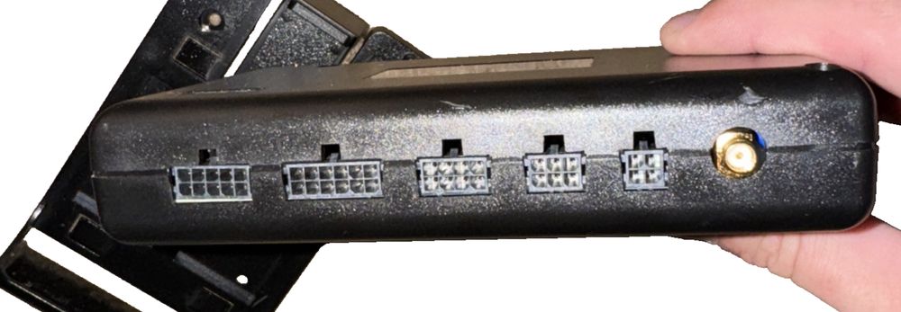 Freightliner ECU Zonar Module - P/N 66-12609-000 – a hand holding a black and white device