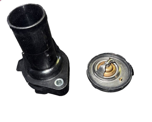 Engine Coolant Thermostat Housing Assembly-Kit Motorad 2313KT – a black plastic water pump with a brass fitting