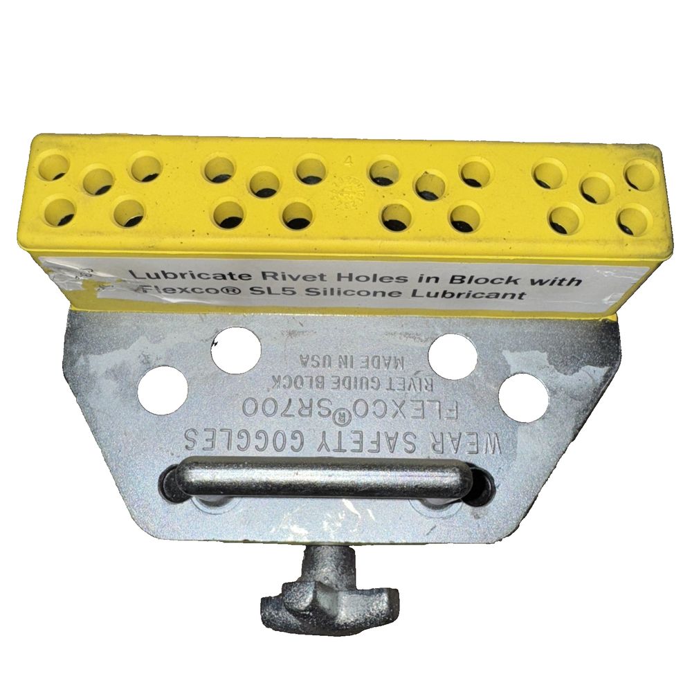 Flexco SR700 Rivet Guide Block – a yellow plastic box with holes and screws
