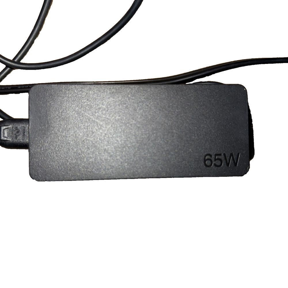 Lenovo 65W AC Adapter – a black cable connected to a white wall