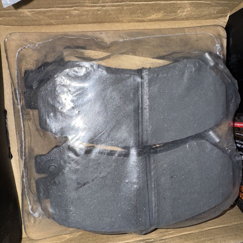 M1273 Ceramic Disc Brake Pads, Elite Max – a box of black shoes with a pair of shoes in it