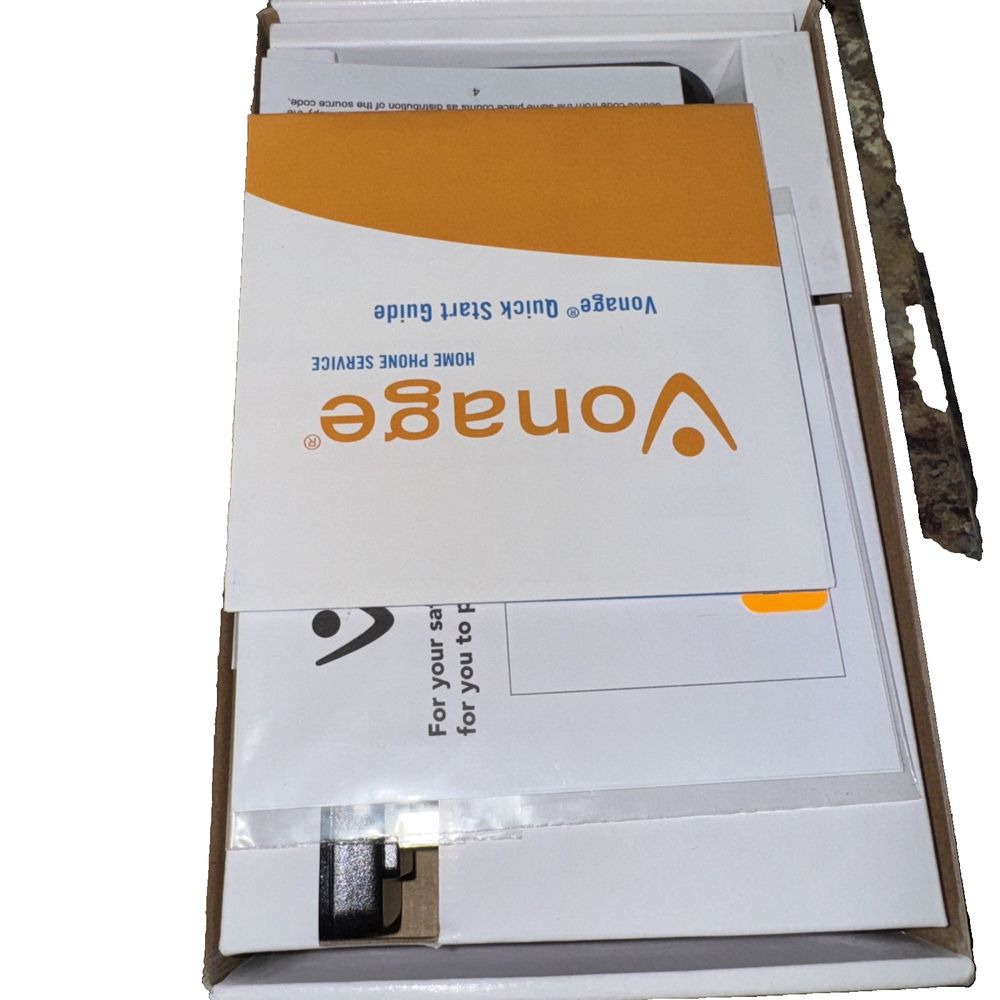 Vonage - HT701 Grandstream – the inside of a box with a white and orange label