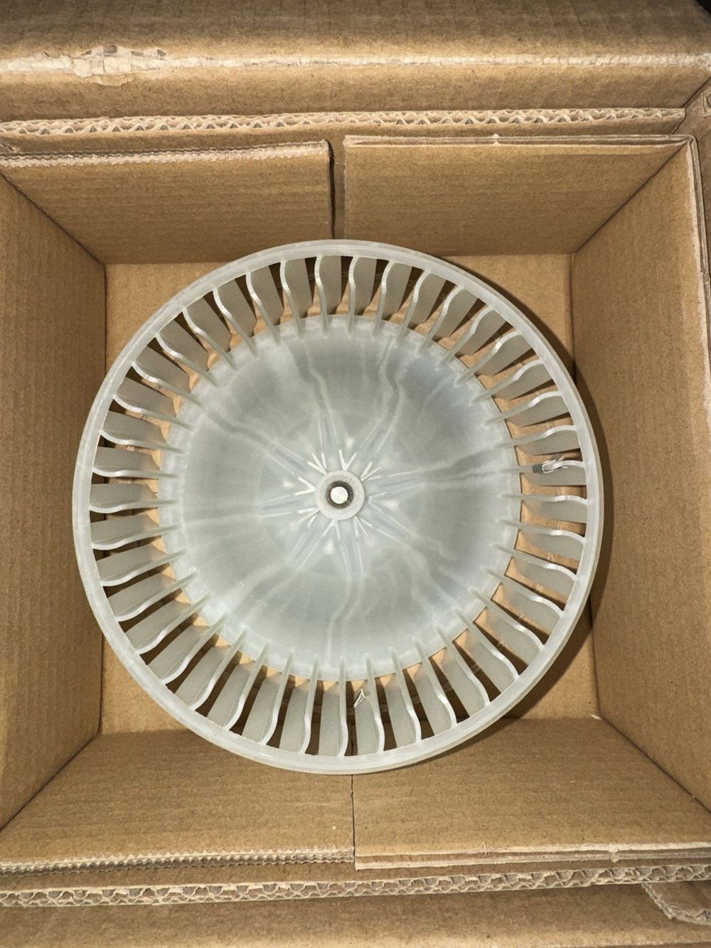 SKP SK700164 Blower Motor, 1 Pack – a white plastic object in a cardboard box